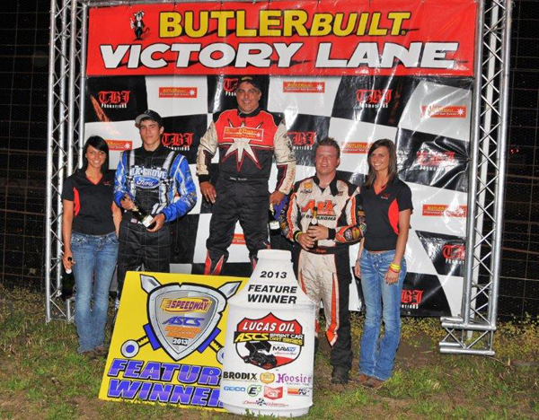 Johnny Herrera stands a top the podium at the U.S. 36 Raceway with the Lucas Oil ASCS presented by MAVTV American Real, after lapping the field up to second finishing Dustin Morgan. It was Herrera's first win of the 2013 season with the ASCS National Tour. (ASCS Photo / John Lee)